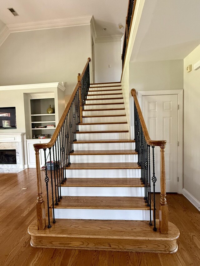 1413 Station Four Ln, Old Hickory, TN 37138 - staircase featuring crown molding, wood finished floors, and a fireplace