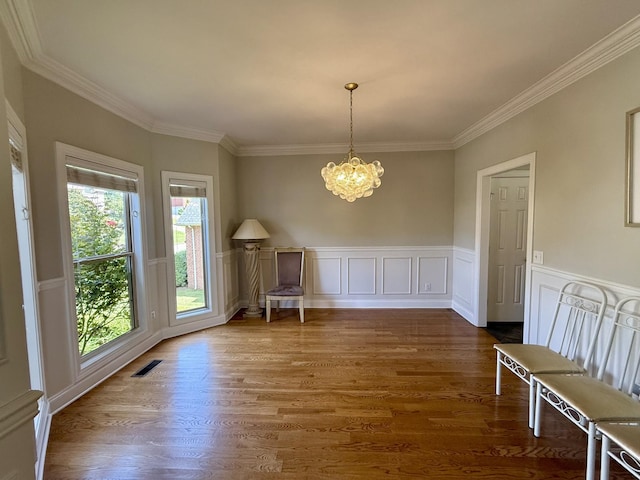 1413 Station Four Ln, Old Hickory, TN 37138 - unfurnished dining area with a chandelier, ornamental molding, wood finished floors, a wainscoted wall, and a decorative wall