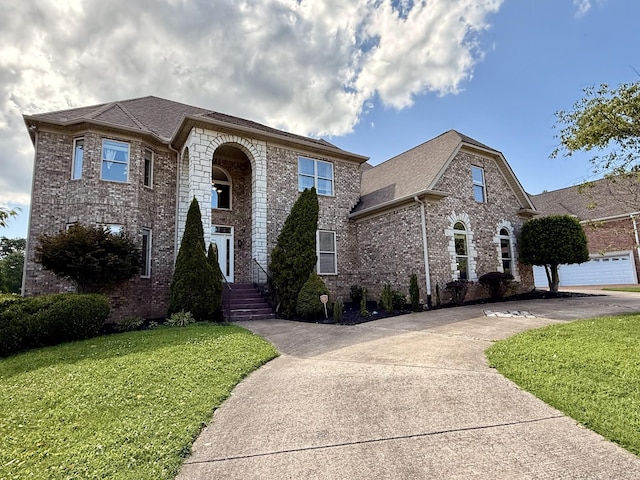 1413 Station Four Ln, Old Hickory, TN 37138 - view of front of property featuring brick siding, a front yard, roof with shingles, and driveway