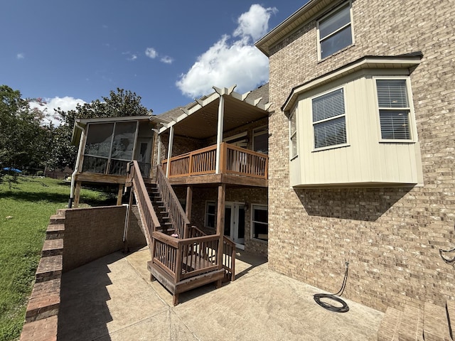 1413 Station Four Ln, Old Hickory, TN 37138 - rear view of property featuring a patio, a sunroom, a wooden deck, a lawn, and stairs