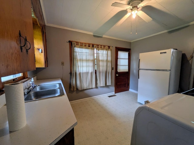 3007 Green Hill Dr, Centerville, TN 37033 - kitchen featuring freestanding refrigerator, light floors, ceiling fan, washer / dryer, and ornamental molding