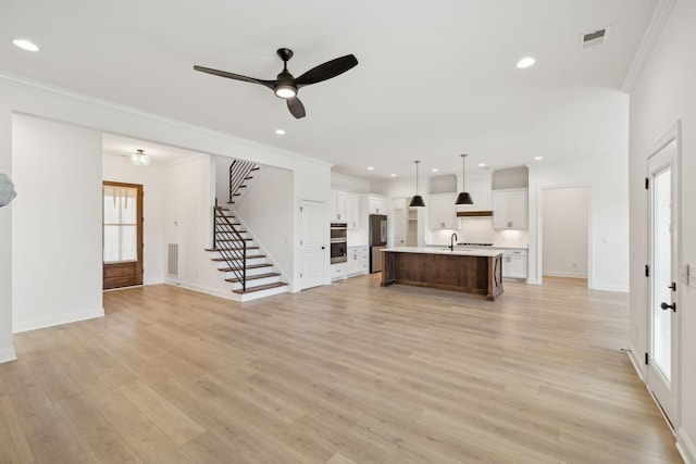 4118 Maples Farm Dr, Murfreesboro, TN 37127 - unfurnished living room featuring stairway, light wood-style floors, a ceiling fan, recessed lighting, and crown molding