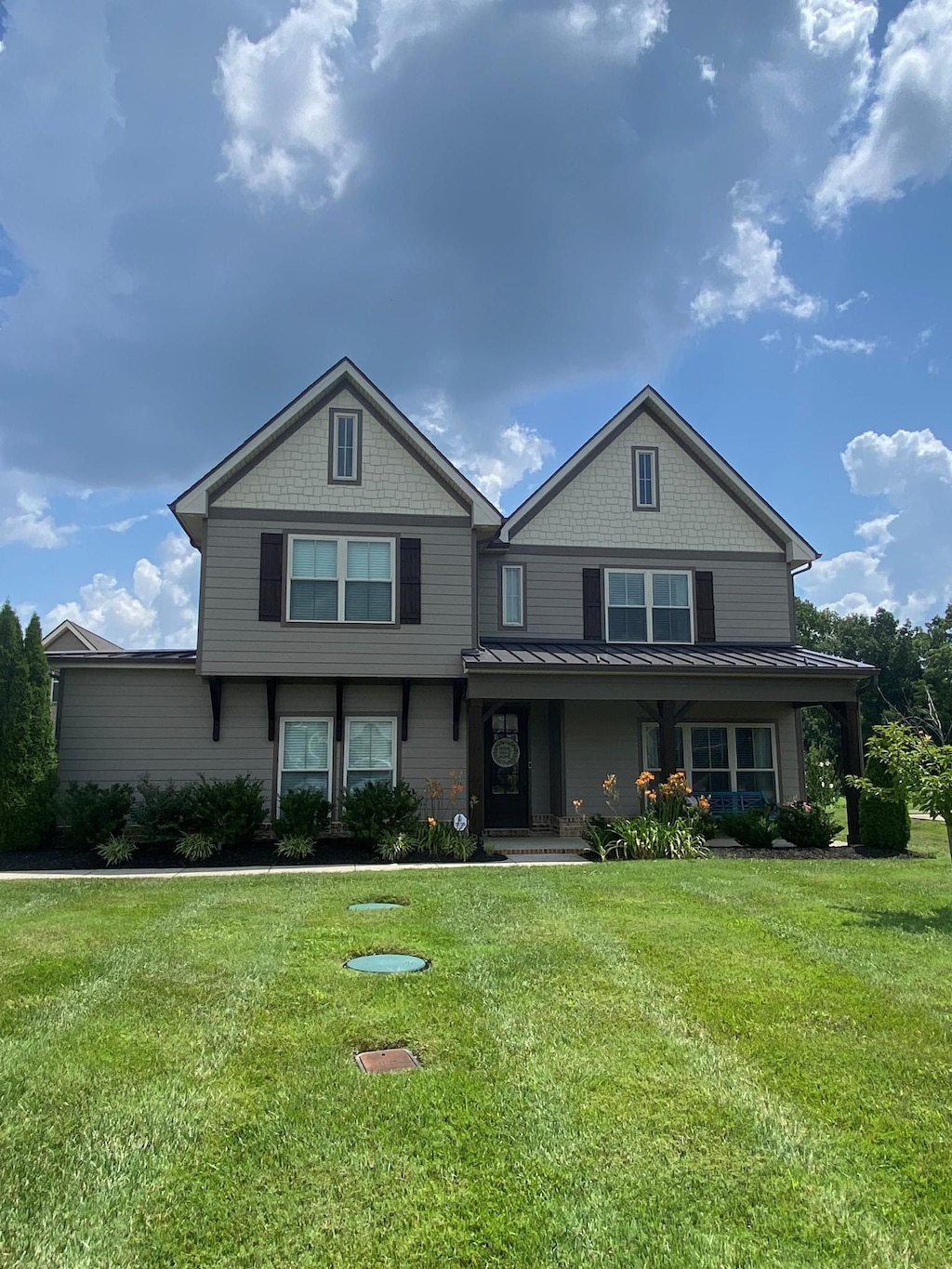 2090 Trout Trl, Murfreesboro, TN 37129 - view of front of house with a standing seam roof, a front yard, a metal roof, and covered porch
