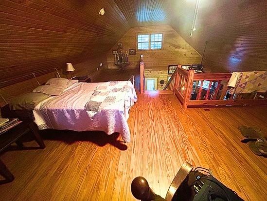 2933 Vanzant Bend Rd, Belvidere, TN 37306 - bedroom featuring wood walls, wood finished floors, and lofted ceiling