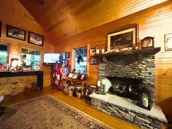 2933 Vanzant Bend Rd, Belvidere, TN 37306 - living area with lofted ceiling, wood finished floors, wooden ceiling, and wood walls