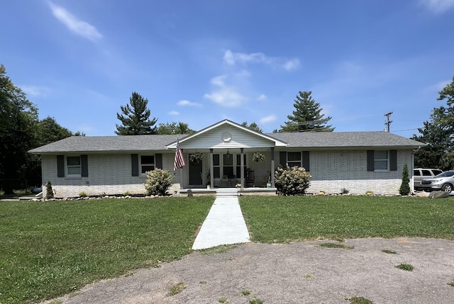 6191 Baxter Rd, Baxter, TN 38544 - ranch-style home featuring brick siding, covered porch, a front lawn, and a shingled roof