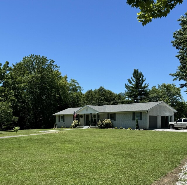 6191 Baxter Rd, Baxter, TN 38544 - ranch-style home with a front yard, an attached garage, and driveway