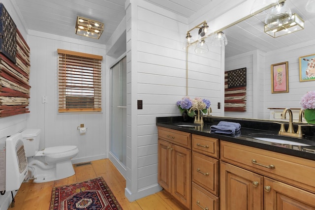 1261 S Cedar Ln, Chickamauga, GA 30707 - bathroom featuring wood-type flooring, double vanity, a stall shower, wooden walls, and heating unit