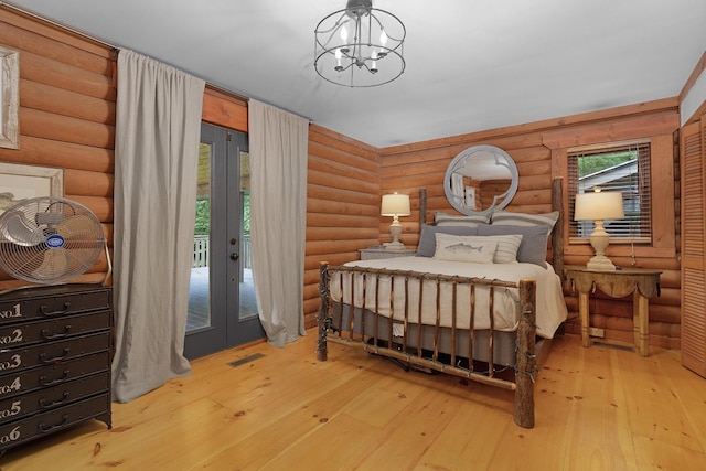 1261 S Cedar Ln, Chickamauga, GA 30707 - bedroom with french doors, rustic walls, access to outside, hardwood / wood-style floors, and a chandelier