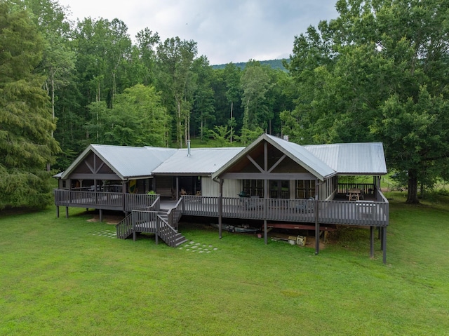 1261 S Cedar Ln, Chickamauga, GA 30707 - back of house featuring a lawn, a metal roof, a deck, and a wooded view
