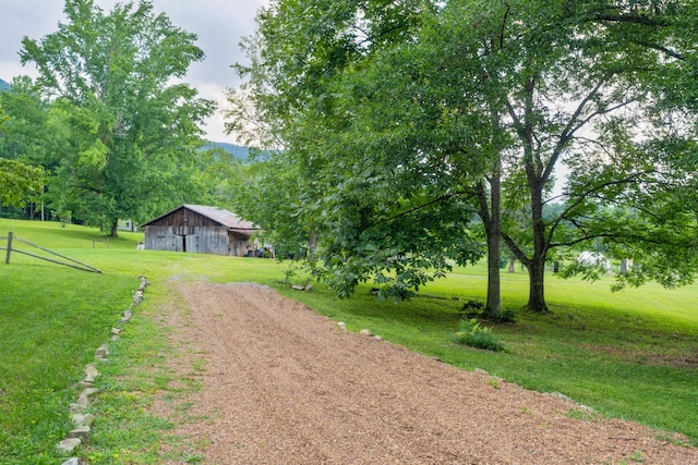 1261 S Cedar Ln, Chickamauga, GA 30707 - view of grassy yard featuring an outdoor structure, dirt driveway, and a detached garage