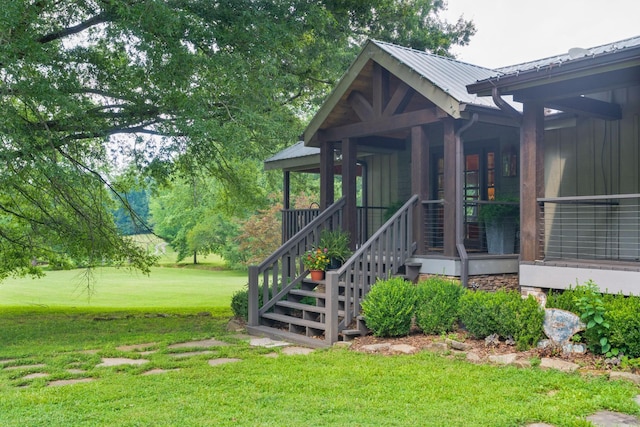 1261 S Cedar Ln, Chickamauga, GA 30707 - view of exterior entry with a lawn and a metal roof