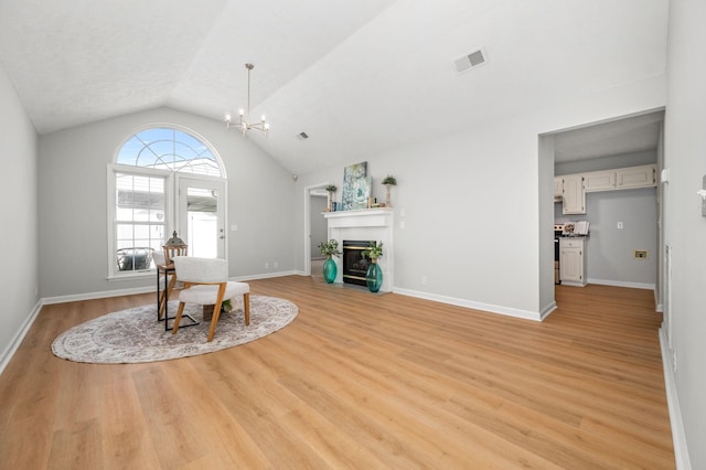785 E Northfield Blvd, Murfreesboro, TN 37130 - dining room featuring light wood-style floors, a chandelier, lofted ceiling, and a fireplace with flush hearth