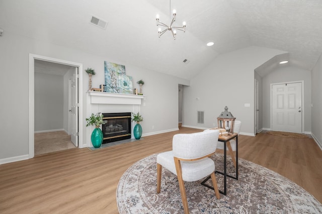 785 E Northfield Blvd, Murfreesboro, TN 37130 - living area featuring wood finished floors, a chandelier, a fireplace with flush hearth, and lofted ceiling