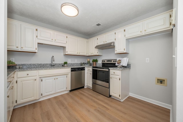 785 E Northfield Blvd, Murfreesboro, TN 37130 - kitchen featuring appliances with stainless steel finishes, under cabinet range hood, light wood finished floors, light stone counters, and a textured ceiling