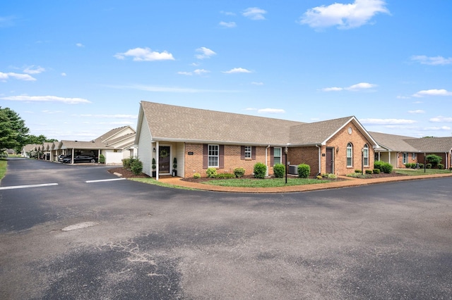 785 E Northfield Blvd, Murfreesboro, TN 37130 - view of front of property featuring brick siding, uncovered parking, and roof with shingles