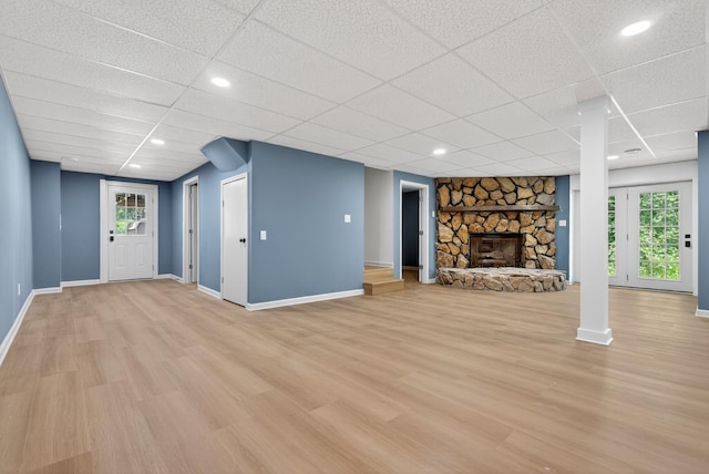 115 Annabelle Way, Ashland City, TN 37015 - unfurnished living room featuring light wood-type flooring, a paneled ceiling, plenty of natural light, and a fireplace