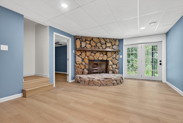 115 Annabelle Way, Ashland City, TN 37015 - unfurnished living room with wood finished floors, a paneled ceiling, and a stone fireplace