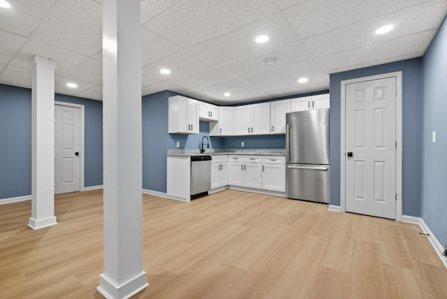 115 Annabelle Way, Ashland City, TN 37015 - kitchen featuring stainless steel appliances, light wood-style flooring, white cabinetry, a drop ceiling, and light stone countertops