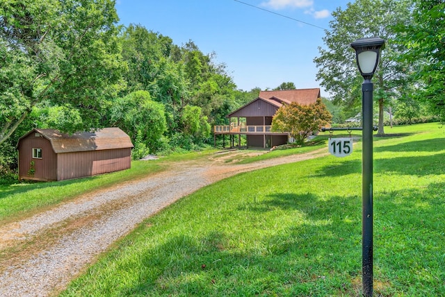 115 Annabelle Way, Ashland City, TN 37015 - view of green lawn with a storage shed, driveway, and a wooden deck