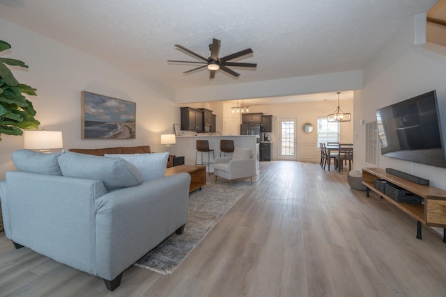 5314 Dan Post Way, Murfreesboro, TN 37128 - living room with a chandelier, light wood finished floors, a ceiling fan, and a textured ceiling