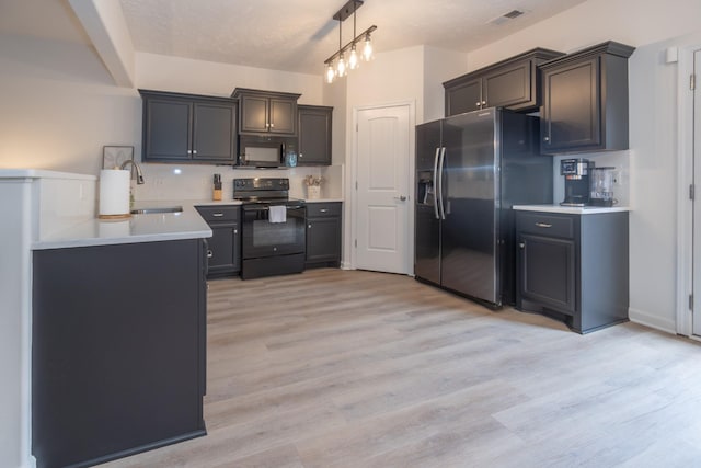 5314 Dan Post Way, Murfreesboro, TN 37128 - kitchen featuring black appliances, light wood-type flooring, light countertops, and pendant lighting