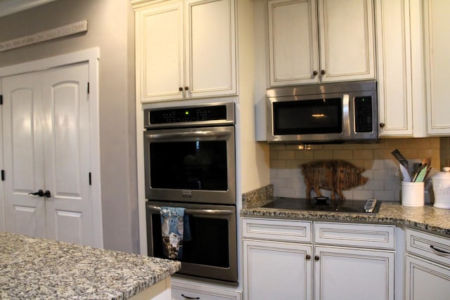 8009 Shelly Plum Dr, Murfreesboro, TN 37128 - kitchen featuring appliances with stainless steel finishes, backsplash, and light stone countertops