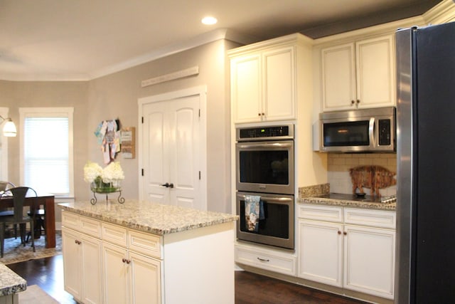 8009 Shelly Plum Dr, Murfreesboro, TN 37128 - kitchen with appliances with stainless steel finishes, dark wood-style floors, tasteful backsplash, light stone counters, and recessed lighting