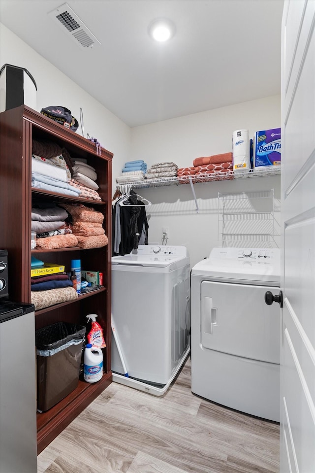 3331 Alta Ln, Murfreesboro, TN 37128 - laundry room featuring washer and clothes dryer and wood finished floors