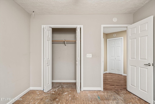 708 Poston Dr, Monterey, TN 38574 - unfurnished bedroom featuring wood finished floors, a closet, and a textured ceiling