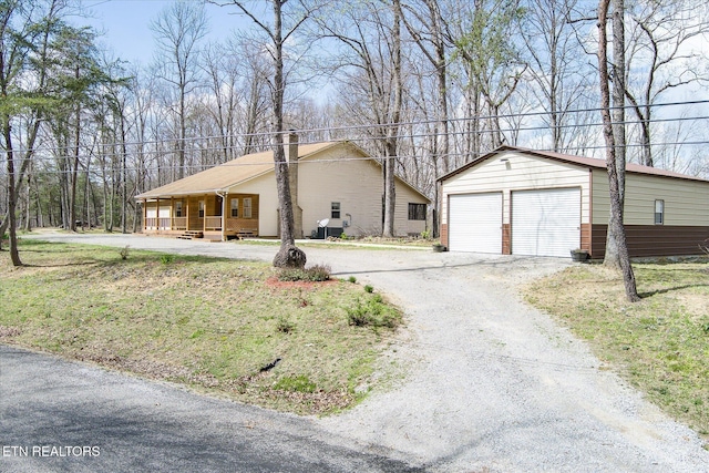 708 Poston Dr, Monterey, TN 38574 - view of front of property featuring a porch, an outbuilding, a detached garage, and a chimney