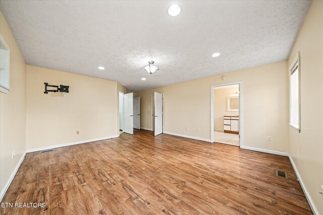 708 Poston Dr, Monterey, TN 38574 - unfurnished room featuring a textured ceiling, light wood-style flooring, and recessed lighting