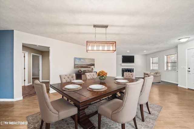 708 Poston Dr, Monterey, TN 38574 - dining room with light wood-style flooring and a fireplace
