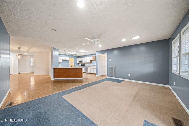708 Poston Dr, Monterey, TN 38574 - unfurnished living room with a textured ceiling, ceiling fan, recessed lighting, and light wood-style flooring