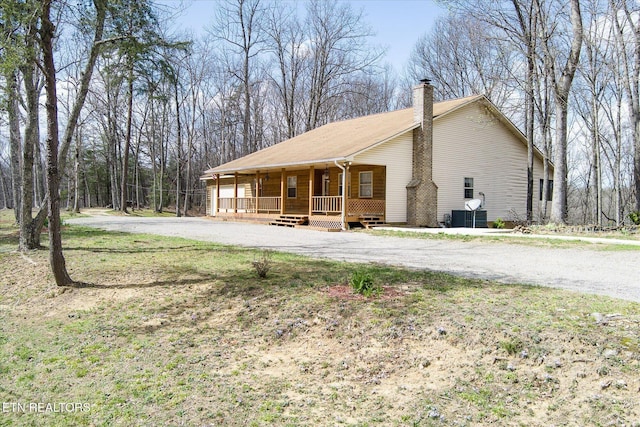 708 Poston Dr, Monterey, TN 38574 - view of side of home with covered porch, driveway, and a chimney