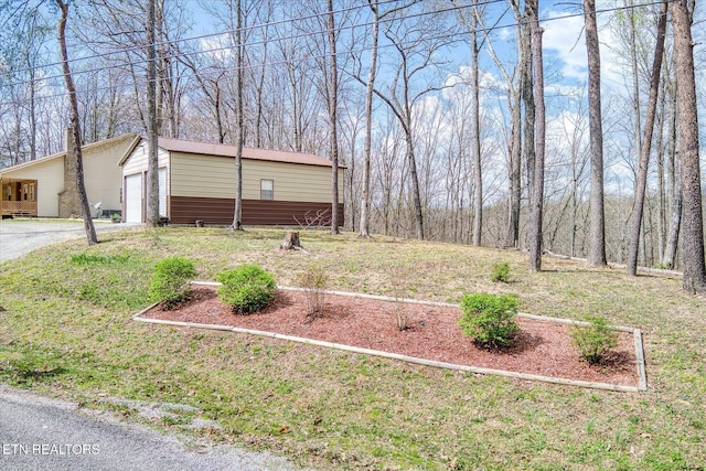 708 Poston Dr, Monterey, TN 38574 - view of yard featuring an outbuilding, driveway, and a garage