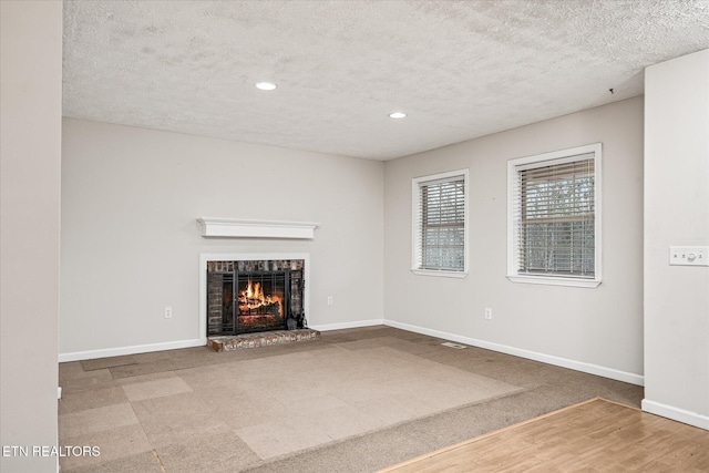 708 Poston Dr, Monterey, TN 38574 - unfurnished living room with a textured ceiling, a fireplace, recessed lighting, and carpet