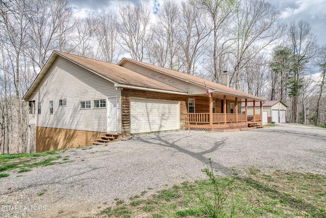 708 Poston Dr, Monterey, TN 38574 - view of side of property with covered porch, a chimney, an attached garage, and an outbuilding