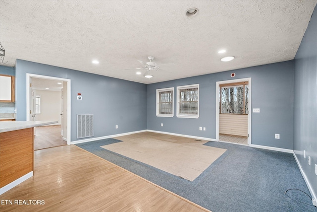 708 Poston Dr, Monterey, TN 38574 - unfurnished living room featuring a textured ceiling, ceiling fan, recessed lighting, and wood finished floors