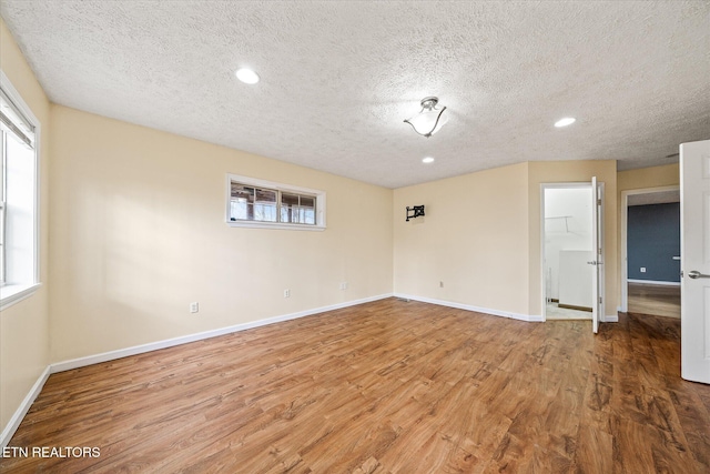 708 Poston Dr, Monterey, TN 38574 - unfurnished room with a textured ceiling, wood finished floors, and recessed lighting