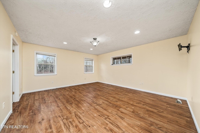 708 Poston Dr, Monterey, TN 38574 - empty room featuring a textured ceiling, wood finished floors, and recessed lighting