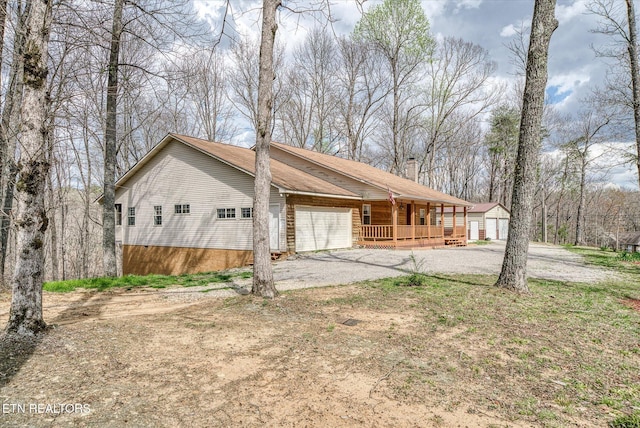 708 Poston Dr, Monterey, TN 38574 - view of side of home with covered porch, an attached garage, and driveway