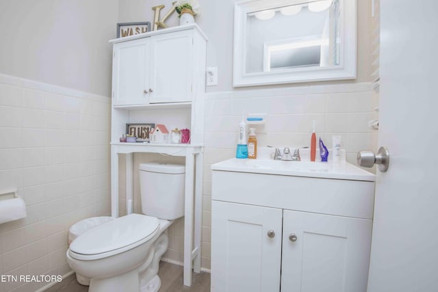 8114 Sharp Rd, Powell, TN 37849 - half bathroom with tile walls, vanity, and a wainscoted wall