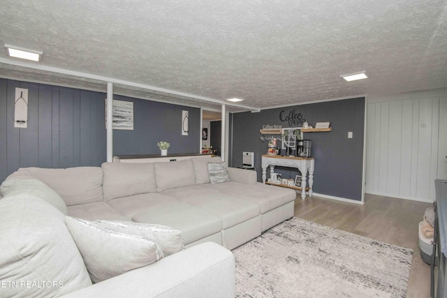 8114 Sharp Rd, Powell, TN 37849 - living room featuring wood finished floors, a textured ceiling, and wood walls