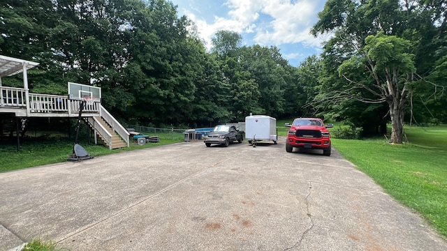 712 Rossview Rd, Clarksville, TN 37043 - view of parking / parking lot featuring stairway, concrete driveway, and view of scattered trees