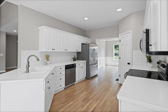 236 Comer Cir, Murfreesboro, TN 37128 - kitchen featuring stainless steel appliances, white cabinets, light wood-style floors, a wainscoted wall, and light countertops