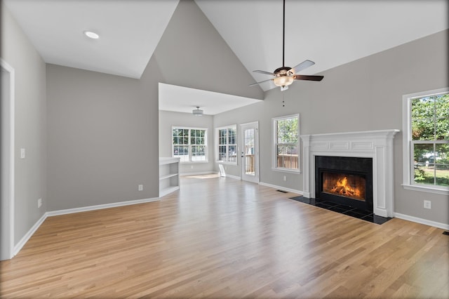 236 Comer Cir, Murfreesboro, TN 37128 - unfurnished living room with a fireplace with flush hearth, light wood-style flooring, high vaulted ceiling, and a ceiling fan