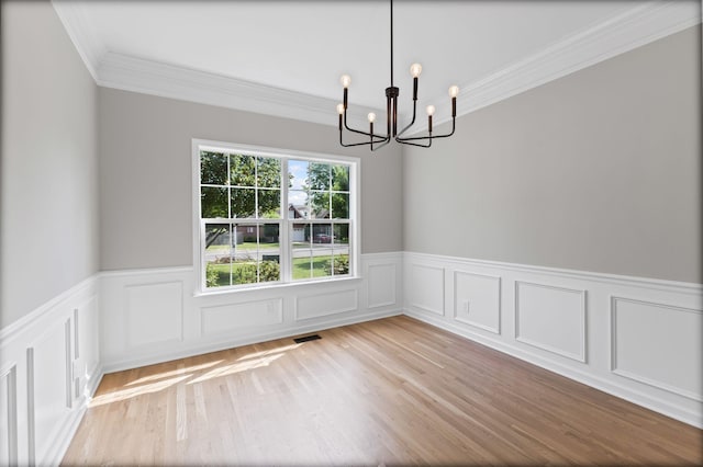 236 Comer Cir, Murfreesboro, TN 37128 - spare room with a chandelier, crown molding, wainscoting, wood finished floors, and a decorative wall