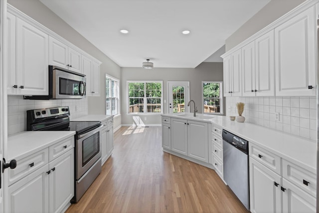 236 Comer Cir, Murfreesboro, TN 37128 - kitchen with stainless steel appliances, light wood-style flooring, white cabinetry, recessed lighting, and light countertops