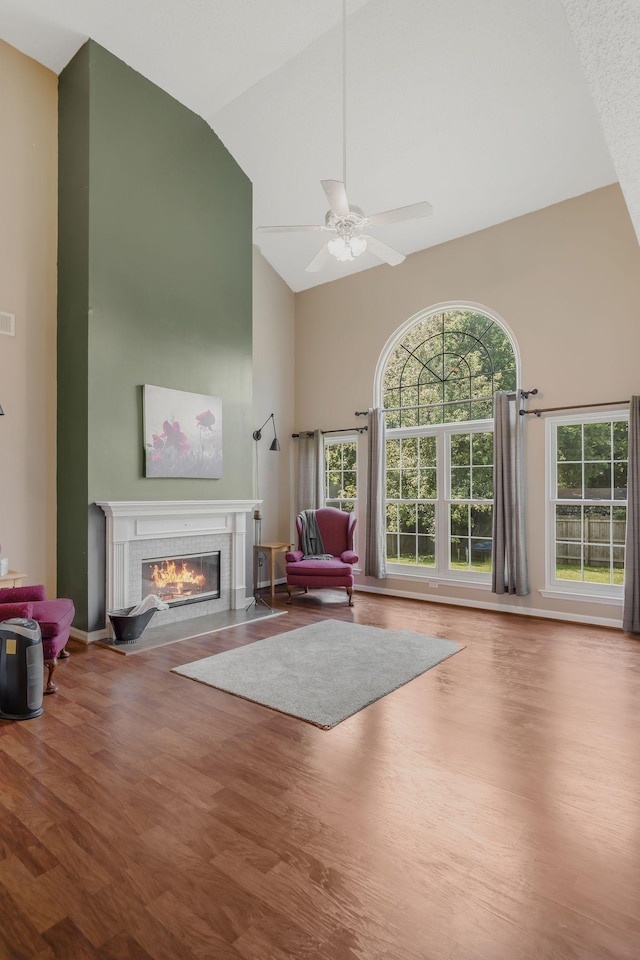 2117 Spring Hill Cir, Spring Hill, TN 37174 - living area featuring high vaulted ceiling, a glass covered fireplace, wood finished floors, and ceiling fan